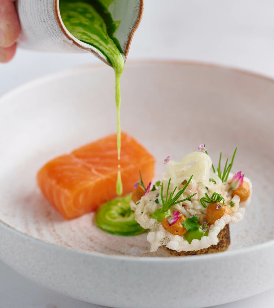 Salmon and wild garlic oil on a fine dining plate